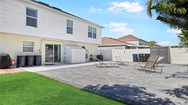 11257 Dacre Ln, Orlando, FL 32824 - back of house featuring fence, a patio, stucco siding, and central air condition unit