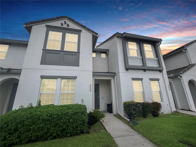 454 Captiva Dr, Davenport, FL 33896 - view of front facade with stucco siding and a front lawn