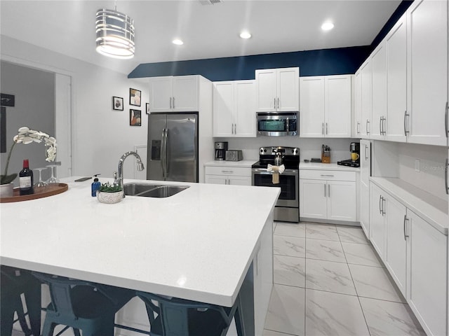 454 Captiva Dr, Davenport, FL 33896 - kitchen featuring stainless steel appliances, light marble finish flooring, light countertops, a sink, and white cabinetry