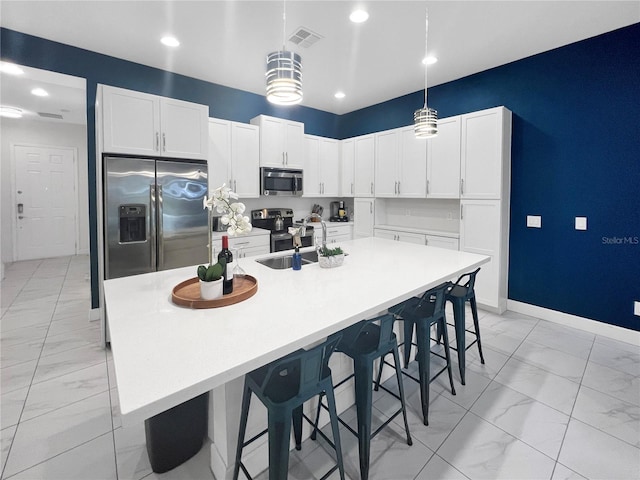 454 Captiva Dr, Davenport, FL 33896 - kitchen featuring stainless steel appliances, light marble finish flooring, a sink, white cabinetry, and recessed lighting