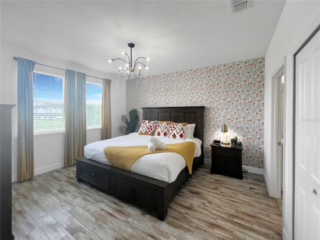 454 Captiva Dr, Davenport, FL 33896 - bedroom featuring a chandelier, baseboards, light wood-style flooring, and wallpapered walls