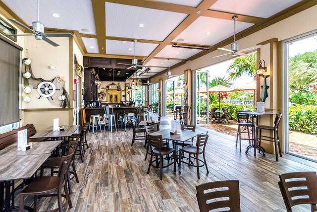 454 Captiva Dr, Davenport, FL 33896 - dining space featuring coffered ceiling, ceiling fan, wood finished floors, recessed lighting, and beam ceiling