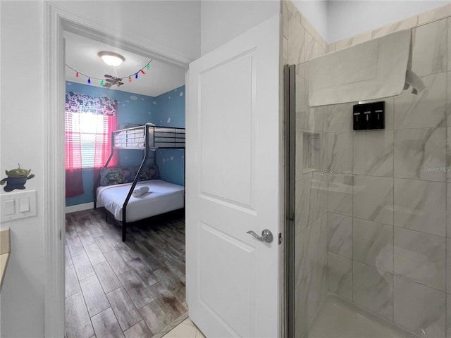 454 Captiva Dr, Davenport, FL 33896 - bathroom featuring a stall shower and wood finished floors