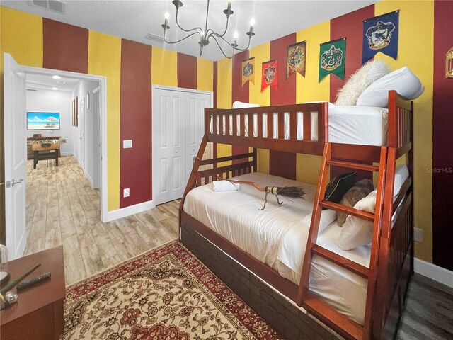 454 Captiva Dr, Davenport, FL 33896 - bedroom with wood finished floors, a chandelier, baseboards, and a closet