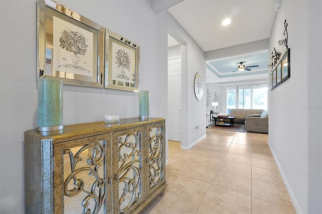 634 Via Corso Ct, Kissimmee, FL 34759 - corridor featuring light tile patterned flooring and a tray ceiling