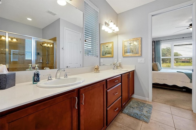 634 Via Corso Ct, Kissimmee, FL 34759 - ensuite bathroom with double vanity, a shower stall, tile patterned floors, and ceiling fan