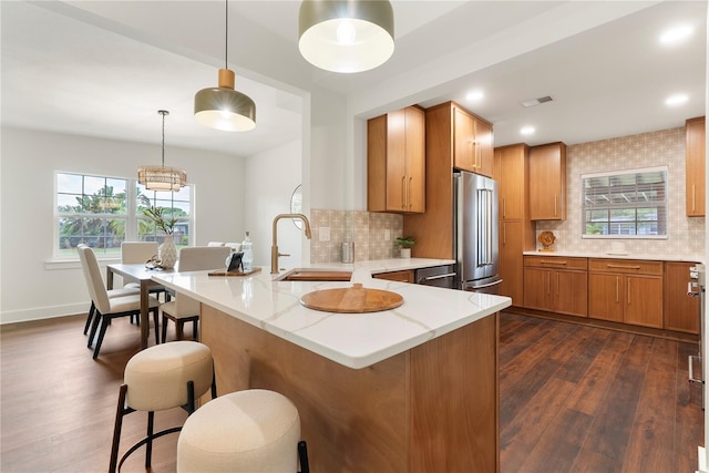 1401 Canberra Ave, Orlando, FL 32806 - kitchen with high quality fridge, dark wood finished floors, a kitchen bar, backsplash, and recessed lighting
