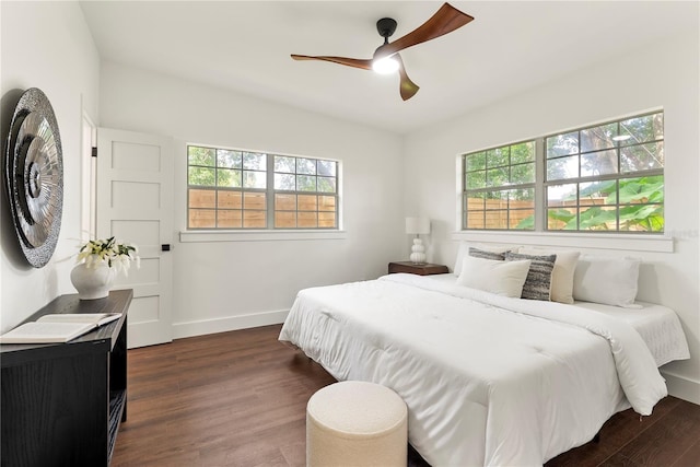 1401 Canberra Ave, Orlando, FL 32806 - bedroom with multiple windows, dark wood finished floors, baseboards, and a ceiling fan