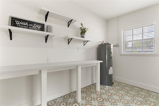 1401 Canberra Ave, Orlando, FL 32806 - laundry room featuring electric water heater and baseboards