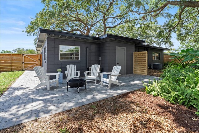 1401 Canberra Ave, Orlando, FL 32806 - view of patio with a fire pit, a gate, and central AC
