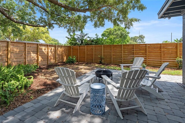 1401 Canberra Ave, Orlando, FL 32806 - fenced backyard with a fire pit and a patio