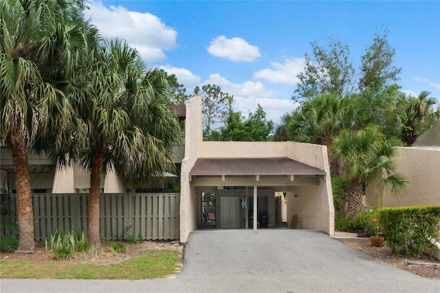 115 Tomoka Trl Unit 115, Longwood, FL 32779 - view of front of home featuring driveway, a carport, and stucco siding