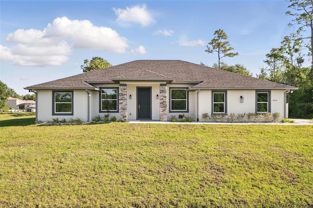 19073 Sabal St, Orlando, FL 32833 - prairie-style house with stucco siding, a front yard, and a shingled roof