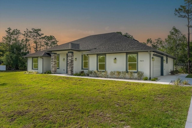 19073 Sabal St, Orlando, FL 32833 - view of front of home featuring stucco siding, a garage, driveway, a lawn, and a shingled roof