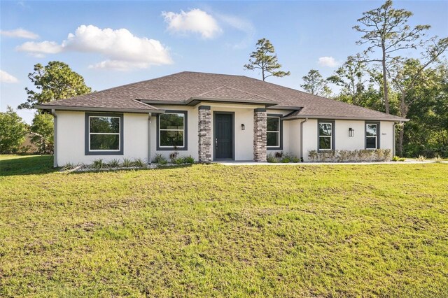19073 Sabal St, Orlando, FL 32833 - prairie-style home with a front lawn, stucco siding, and roof with shingles