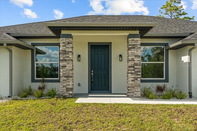 19073 Sabal St, Orlando, FL 32833 - property entrance featuring stucco siding, roof with shingles, a lawn, and stone siding