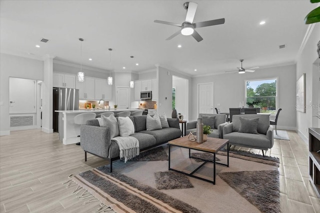 19073 Sabal St, Orlando, FL 32833 - living room with a ceiling fan, recessed lighting, baseboards, ornamental molding, and light wood-style floors