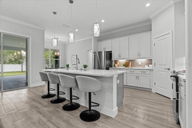 19073 Sabal St, Orlando, FL 32833 - kitchen with appliances with stainless steel finishes, light countertops, recessed lighting, tasteful backsplash, and a kitchen breakfast bar