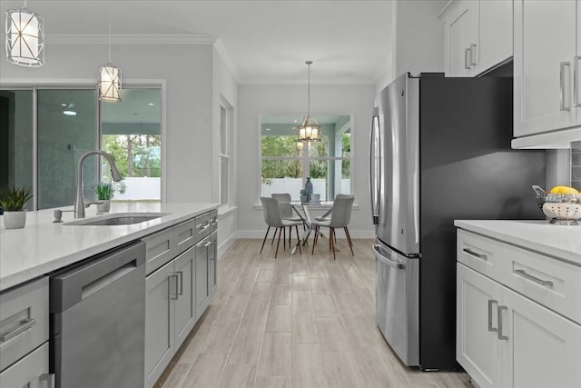 19073 Sabal St, Orlando, FL 32833 - kitchen featuring a sink, appliances with stainless steel finishes, healthy amount of natural light, baseboards, and ornamental molding