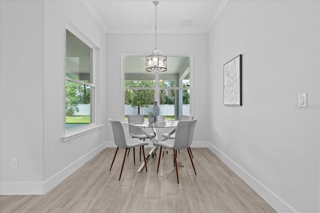19073 Sabal St, Orlando, FL 32833 - dining room featuring crown molding, light wood-type flooring, baseboards, and a chandelier
