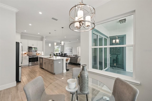 19073 Sabal St, Orlando, FL 32833 - dining area featuring a chandelier, ornamental molding, recessed lighting, light wood-style floors, and baseboards