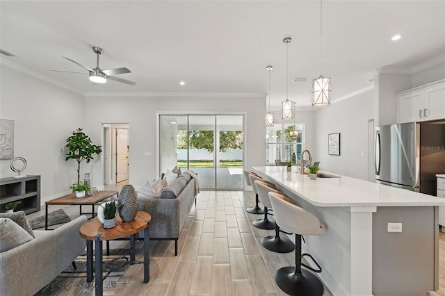 19073 Sabal St, Orlando, FL 32833 - kitchen with open floor plan, a sink, light countertops, ceiling fan, and white cabinets