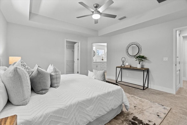 19073 Sabal St, Orlando, FL 32833 - carpeted bedroom with a raised ceiling, baseboards, a spacious closet, and ensuite bathroom