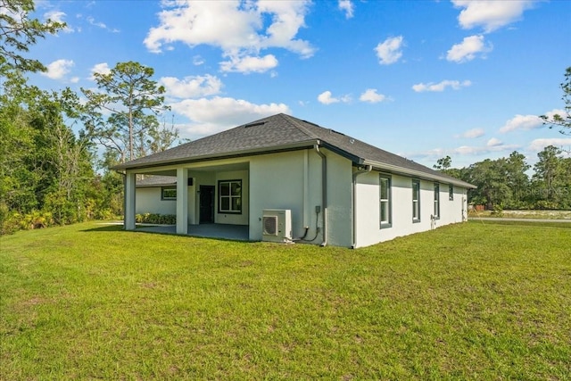 19073 Sabal St, Orlando, FL 32833 - rear view of house featuring stucco siding, a cooling unit, a lawn, and a patio area