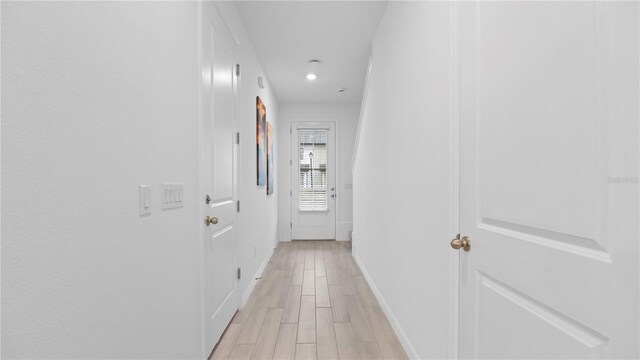 733 Longboat Dr, Davenport, FL 33896 - hall featuring baseboards, light wood-style floors, and recessed lighting
