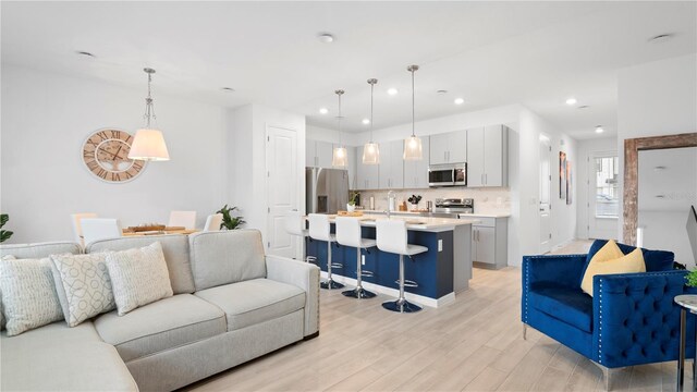 733 Longboat Dr, Davenport, FL 33896 - living room featuring light wood-style flooring and recessed lighting