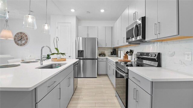 733 Longboat Dr, Davenport, FL 33896 - kitchen featuring stainless steel appliances, gray cabinets, a sink, and recessed lighting