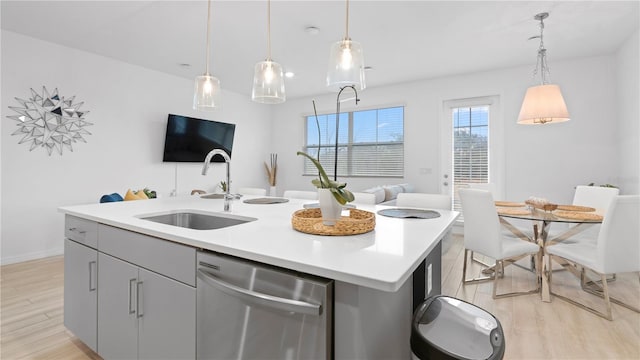 733 Longboat Dr, Davenport, FL 33896 - kitchen featuring dishwasher, a sink, light wood finished floors, and a kitchen island with sink