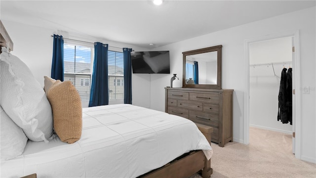 733 Longboat Dr, Davenport, FL 33896 - bedroom with a walk in closet, light colored carpet, a closet, and baseboards