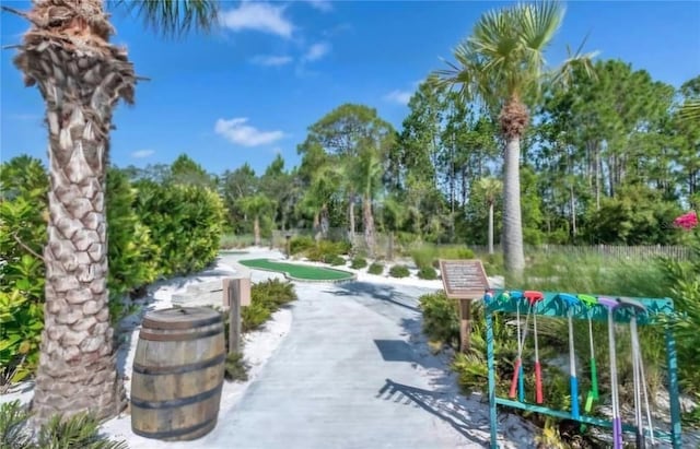 733 Longboat Dr, Davenport, FL 33896 - surrounding community with a putting green and view of wooded area