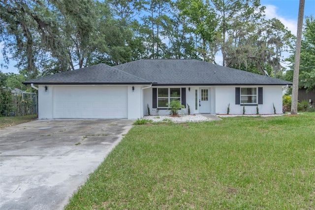 ranch-style house featuring stucco siding, an attached garage, and driveway