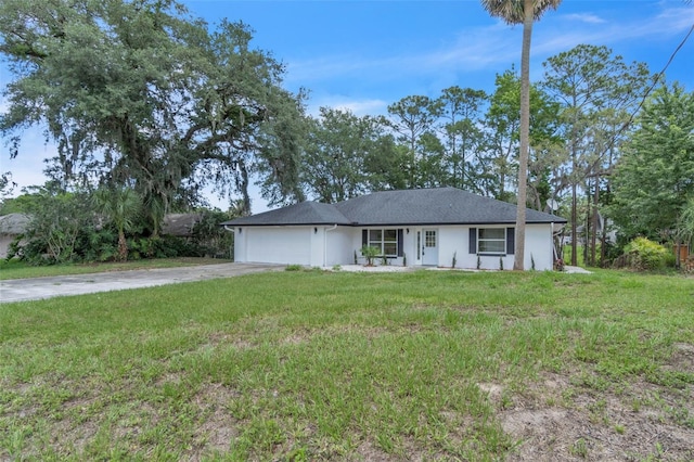 ranch-style house featuring an attached garage, concrete driveway, and a front lawn