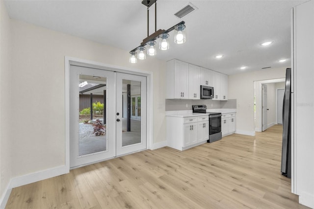 kitchen with stainless steel appliances, baseboards, light wood-style floors, light countertops, and white cabinets