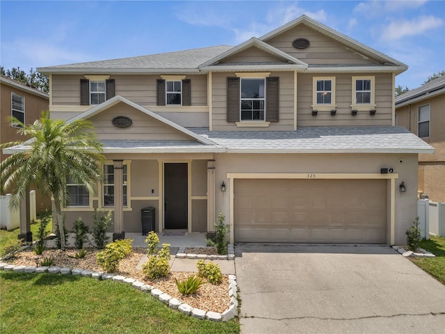 325 Aldridge Ln, Davenport, FL 33897 - view of front of house with driveway, a garage, a shingled roof, and covered porch