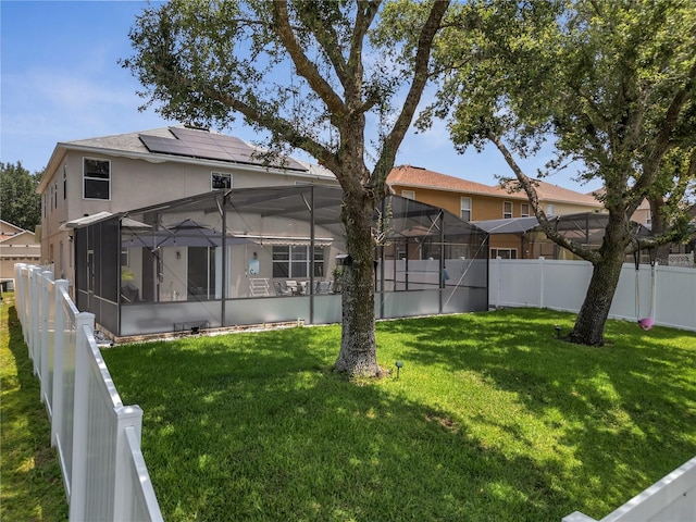 325 Aldridge Ln, Davenport, FL 33897 - back of property with stucco siding, solar panels, and glass enclosure