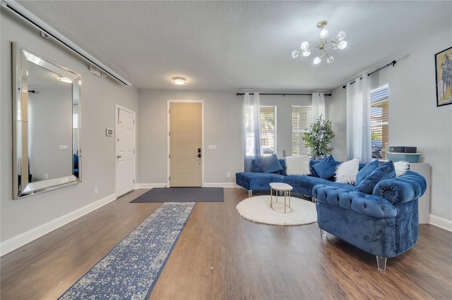 325 Aldridge Ln, Davenport, FL 33897 - living room featuring a textured ceiling, dark wood finished floors, and baseboards