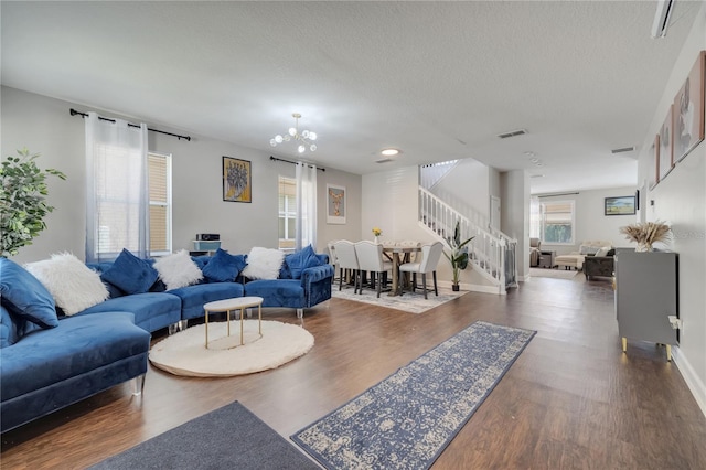 325 Aldridge Ln, Davenport, FL 33897 - living room with stairs, a chandelier, wood finished floors, a textured ceiling, and baseboards
