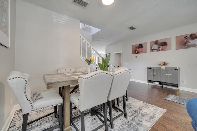 325 Aldridge Ln, Davenport, FL 33897 - dining room with stairs, dark wood-style floors, and baseboards