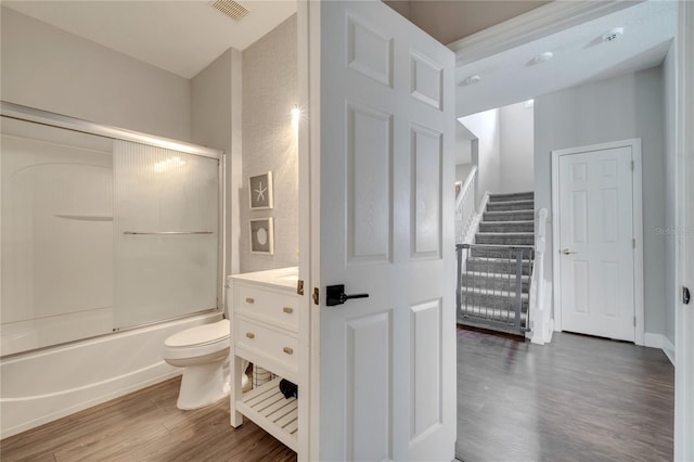 325 Aldridge Ln, Davenport, FL 33897 - bathroom with wood finished floors, toilet, combined bath / shower with glass door, and vanity