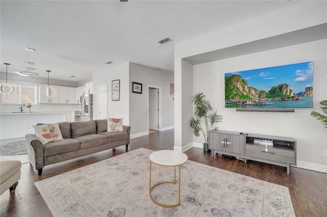 325 Aldridge Ln, Davenport, FL 33897 - living area with dark wood-style floors and baseboards
