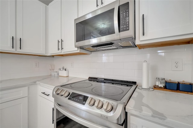325 Aldridge Ln, Davenport, FL 33897 - kitchen with appliances with stainless steel finishes, white cabinets, and backsplash