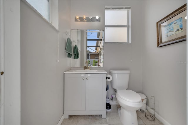 325 Aldridge Ln, Davenport, FL 33897 - bathroom with toilet, vanity, baseboards, and tile patterned flooring