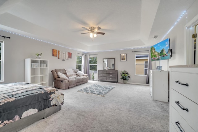 325 Aldridge Ln, Davenport, FL 33897 - bedroom featuring a tray ceiling, light colored carpet, baseboards, and ceiling fan