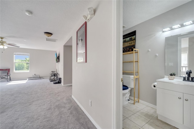 325 Aldridge Ln, Davenport, FL 33897 - corridor featuring a textured ceiling, a sink, and baseboards