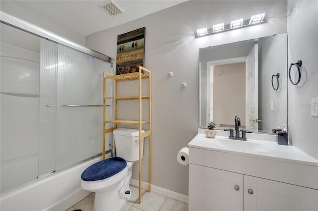 325 Aldridge Ln, Davenport, FL 33897 - full bath featuring vanity, toilet, bath / shower combo with glass door, tile patterned flooring, and baseboards
