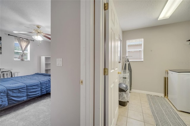 325 Aldridge Ln, Davenport, FL 33897 - laundry area featuring ceiling fan, a textured ceiling, light tile patterned floors, and baseboards